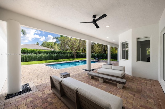 view of patio / terrace featuring ceiling fan, an outdoor hangout area, and a fenced in pool