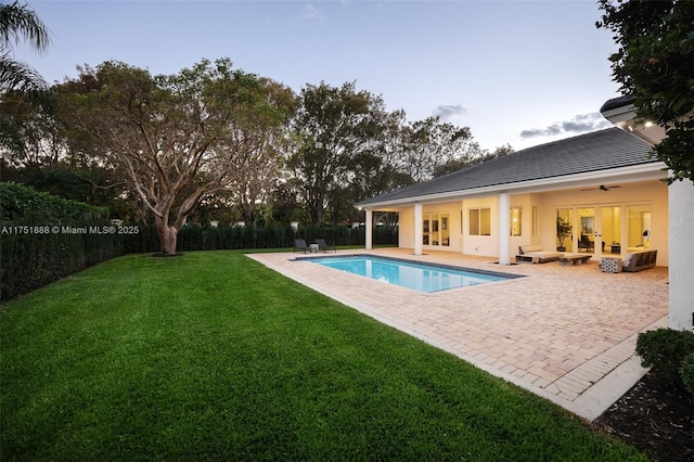 view of swimming pool featuring a patio, a lawn, a fenced backyard, and a fenced in pool