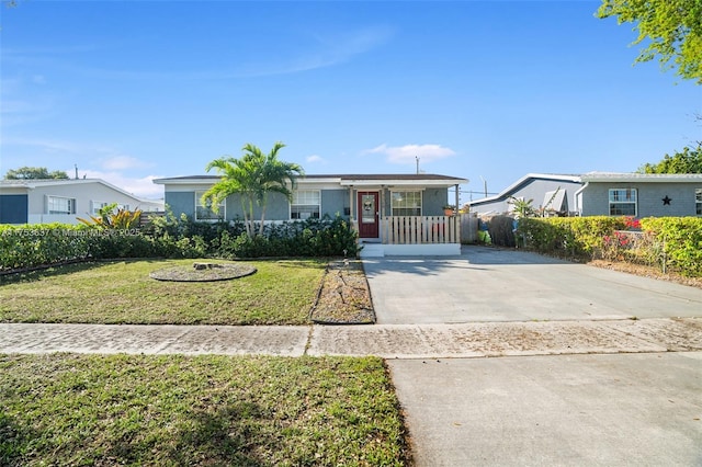 view of front of home with driveway, a front yard, and fence