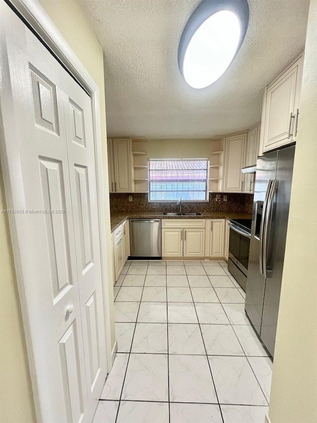 kitchen featuring dark countertops, appliances with stainless steel finishes, and open shelves