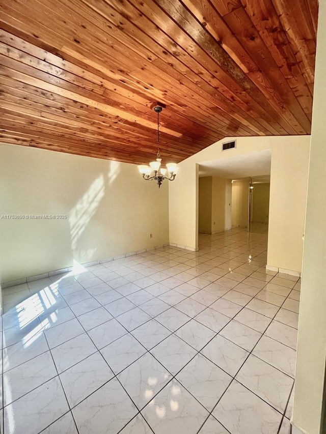 unfurnished room with a chandelier, marble finish floor, wooden ceiling, and visible vents