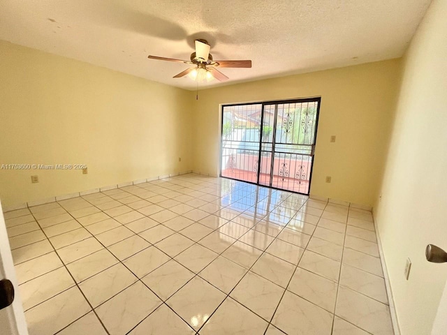 unfurnished room with ceiling fan, a textured ceiling, and light tile patterned flooring