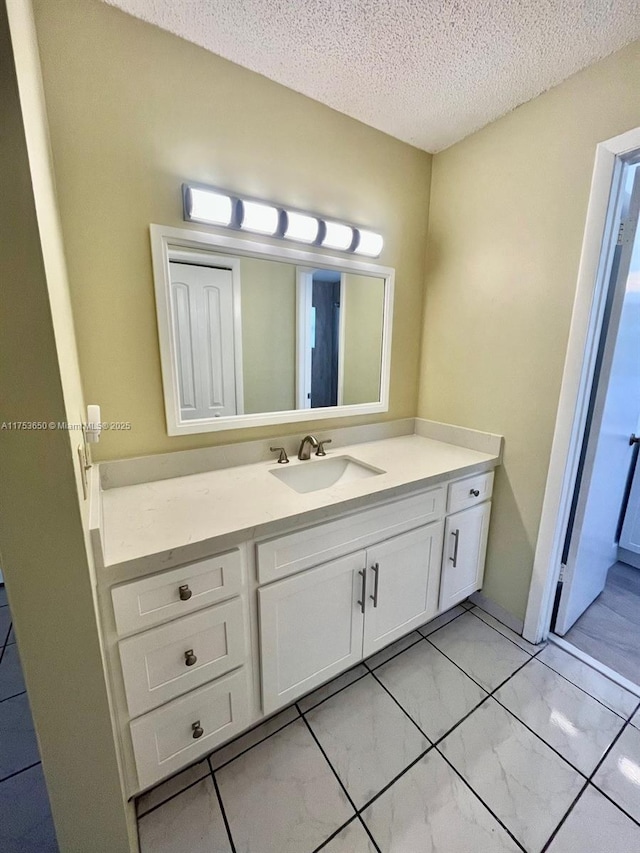 bathroom with a textured ceiling and vanity