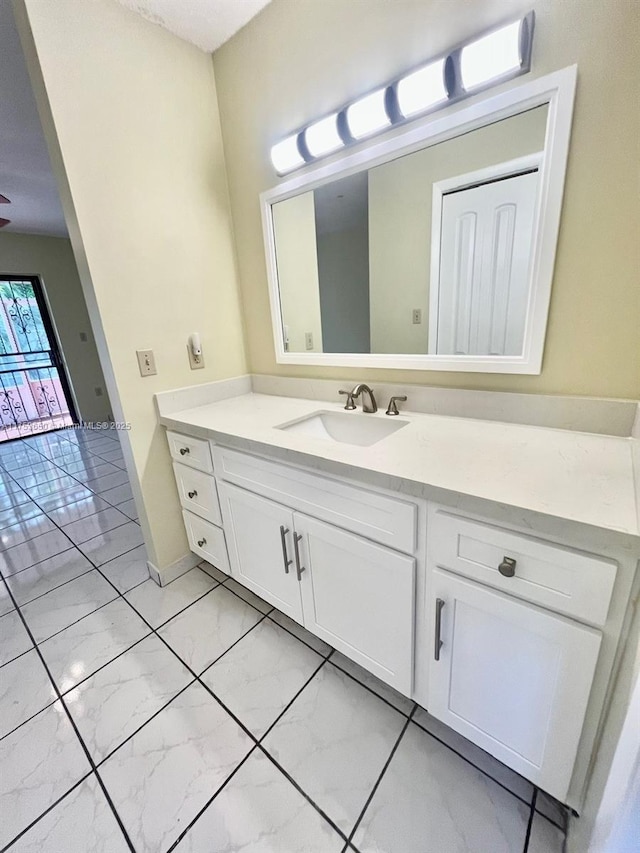 bathroom with marble finish floor and vanity