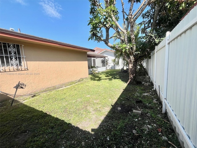 view of yard with a fenced backyard