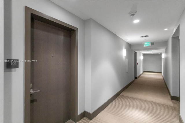 corridor featuring recessed lighting, visible vents, and baseboards