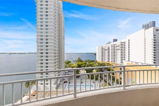 balcony featuring a view of city and a water view