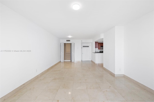 unfurnished room with visible vents and baseboards