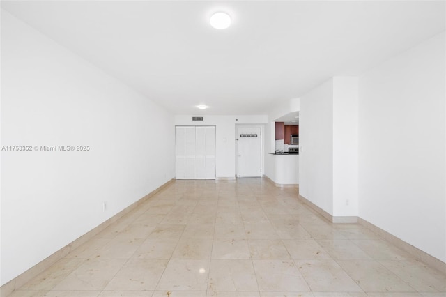 empty room featuring visible vents and baseboards