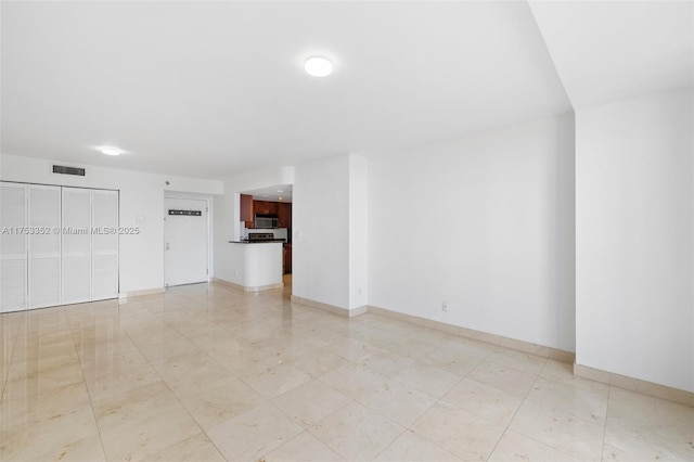 unfurnished room featuring visible vents and baseboards