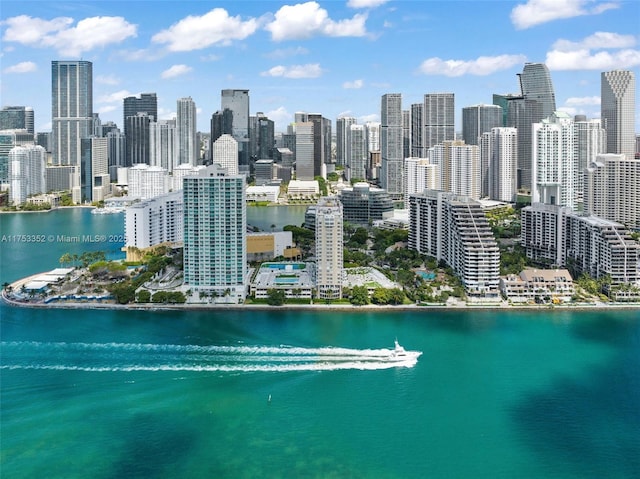 birds eye view of property with a view of city and a water view