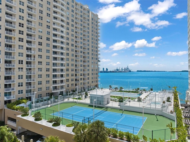 property view of water featuring fence and a city view