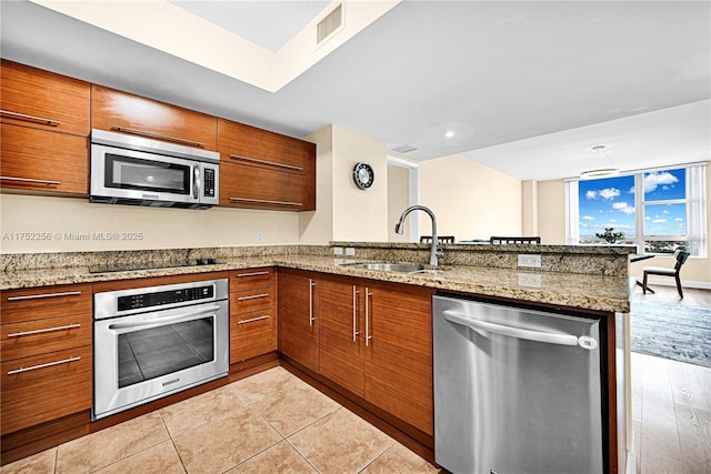2681 N Flamingo Rd Unit 1103S, Sunrise, FL 33323 - kitchen with stainless steel appliances, a sink, and brown cabinetry