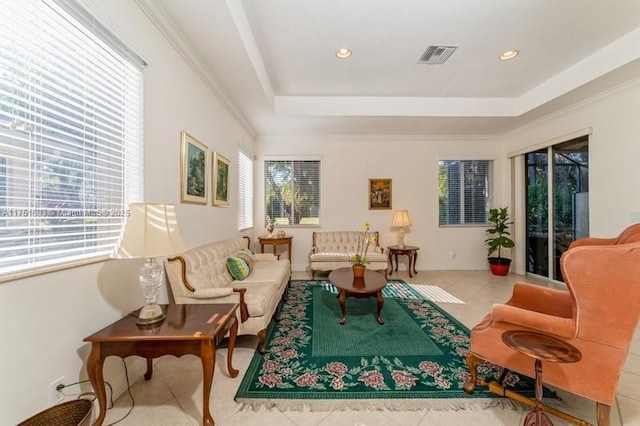 interior space with tile patterned flooring, ornamental molding, a raised ceiling, and recessed lighting