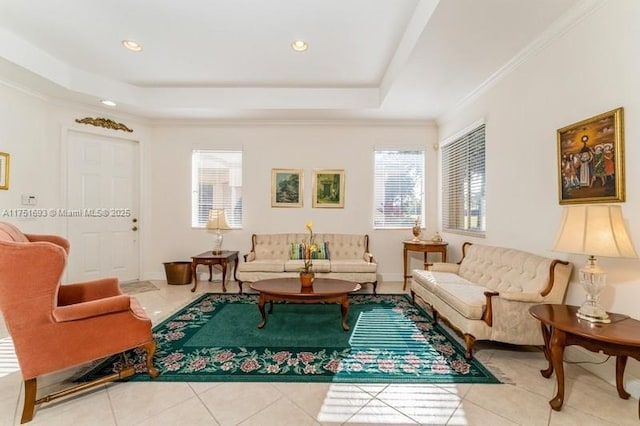 living area featuring crown molding, recessed lighting, a raised ceiling, tile patterned flooring, and baseboards