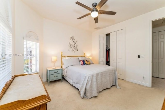 bedroom with a closet, light carpet, ceiling fan, and baseboards