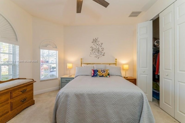 bedroom with baseboards, a closet, visible vents, and light colored carpet