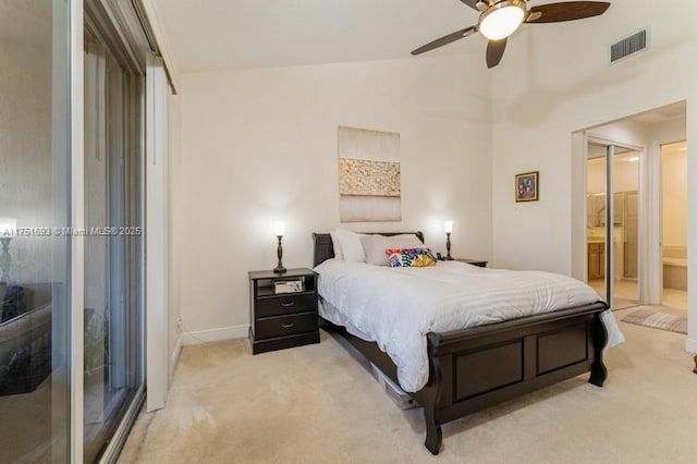 bedroom featuring light carpet, visible vents, a ceiling fan, connected bathroom, and lofted ceiling