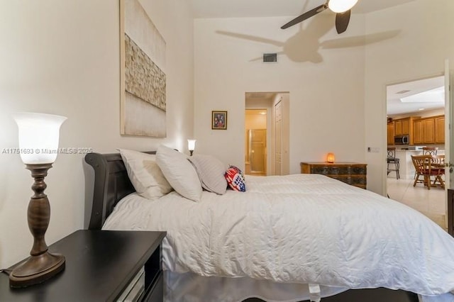 bedroom featuring connected bathroom, visible vents, and a ceiling fan