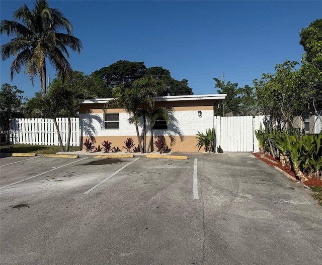 uncovered parking lot with a gate and fence