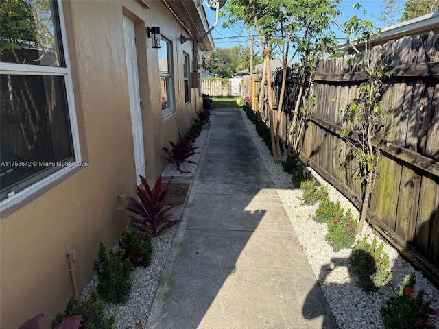 exterior space featuring stucco siding and fence