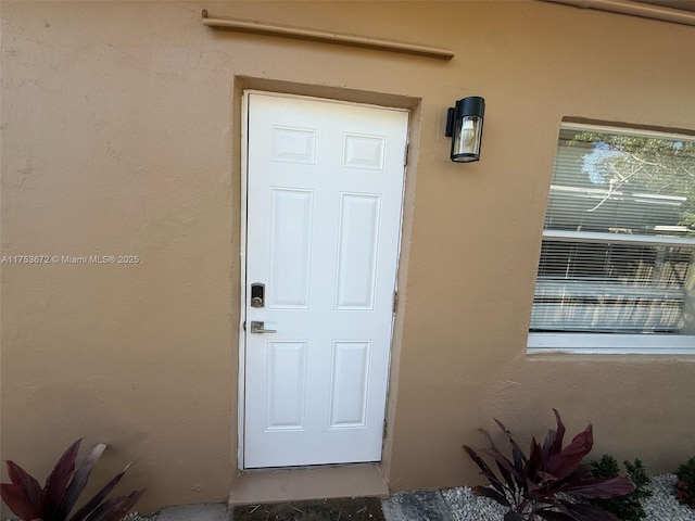 entrance to property with stucco siding