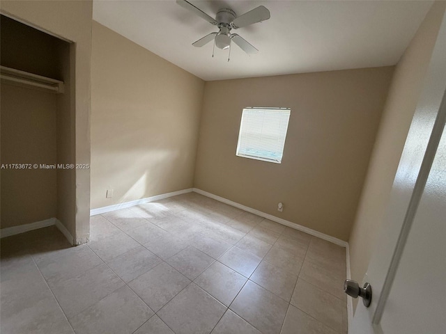 unfurnished bedroom with a ceiling fan, tile patterned flooring, and baseboards