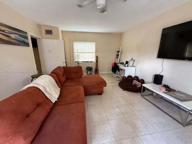 living room featuring light tile patterned floors and visible vents