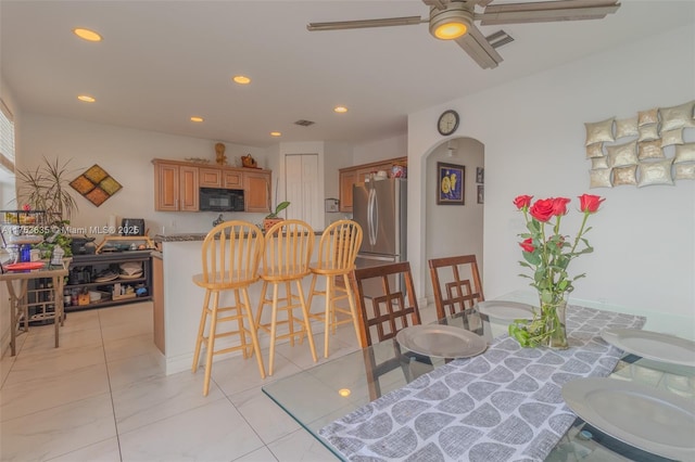 dining area with arched walkways, ceiling fan, light tile patterned flooring, recessed lighting, and visible vents