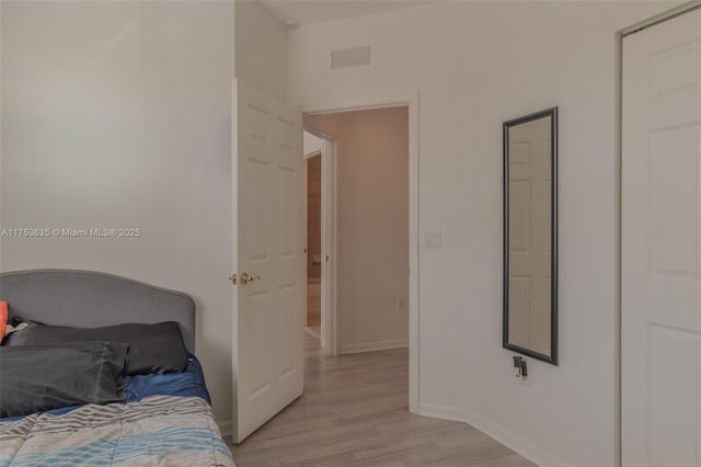 bedroom featuring light wood-style floors, baseboards, and visible vents