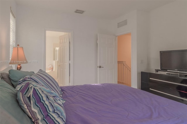 bedroom featuring connected bathroom and visible vents