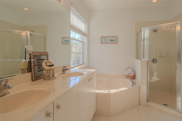 bathroom with a sink, a shower stall, and a bath