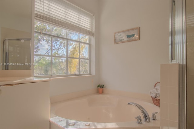 bathroom featuring a garden tub and a stall shower