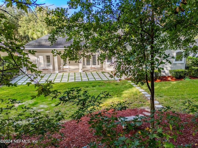 view of yard featuring french doors and a patio