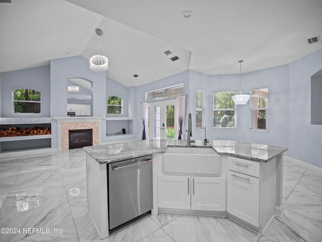 kitchen with dishwasher, light stone counters, a sink, and visible vents