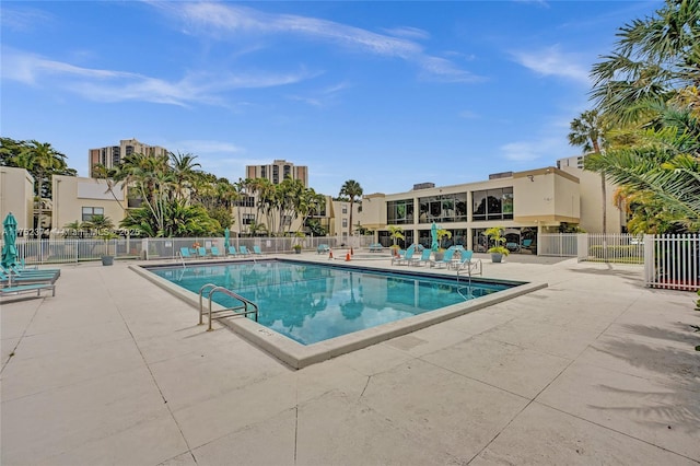 pool featuring fence and a patio