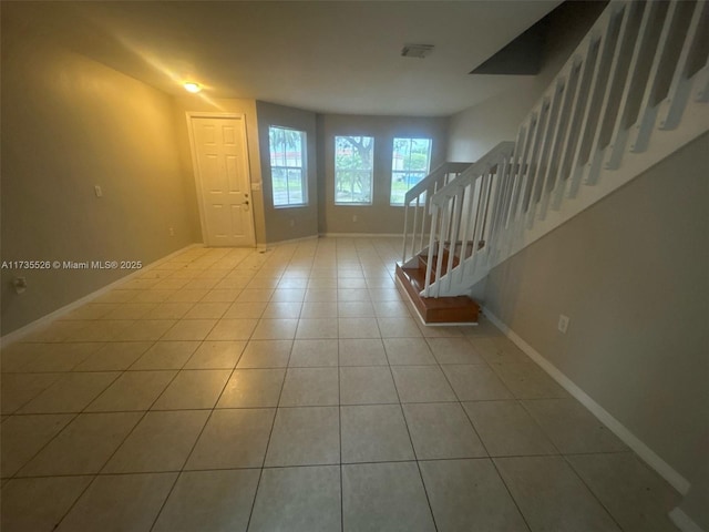 entryway featuring visible vents, stairway, baseboards, and tile patterned floors