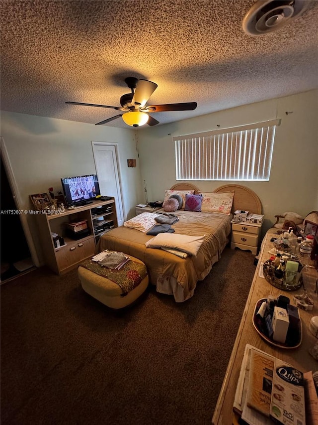 carpeted bedroom with a textured ceiling and ceiling fan