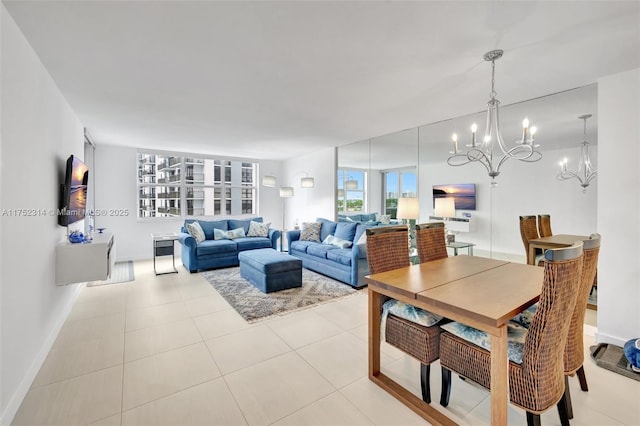 living room featuring baseboards, an inviting chandelier, and light tile patterned floors