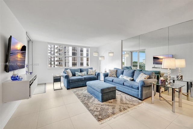 living room featuring baseboards and light tile patterned floors