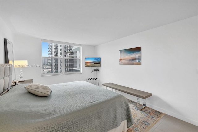 bedroom featuring tile patterned flooring and baseboards