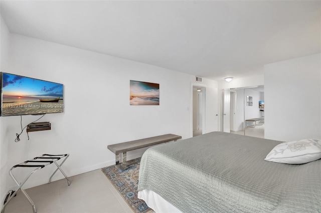 tiled bedroom with visible vents and baseboards