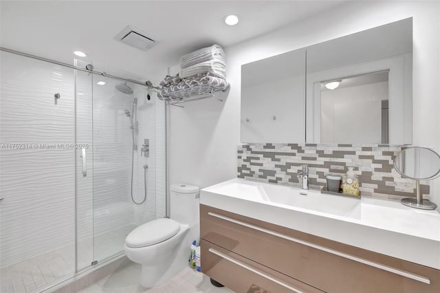 full bathroom featuring toilet, vanity, visible vents, tasteful backsplash, and a stall shower