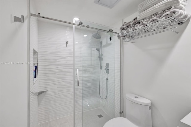 bathroom with a stall shower and toilet