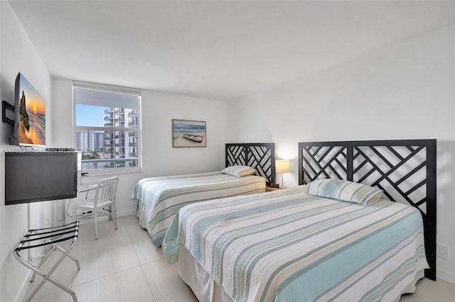 bedroom featuring baseboards and light tile patterned flooring