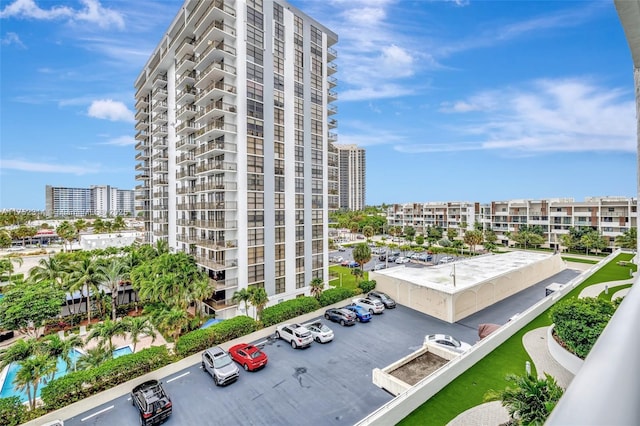 view of property with a view of city and uncovered parking