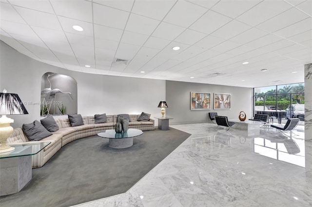 living area with arched walkways, marble finish floor, visible vents, and recessed lighting