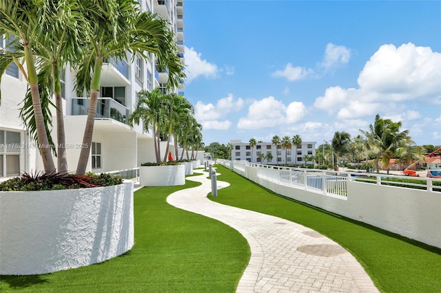 surrounding community featuring fence and a lawn