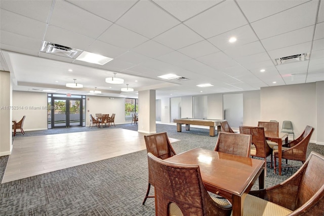 dining area featuring french doors, a drop ceiling, visible vents, and baseboards