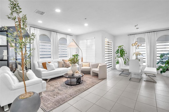 tiled living area with visible vents and recessed lighting